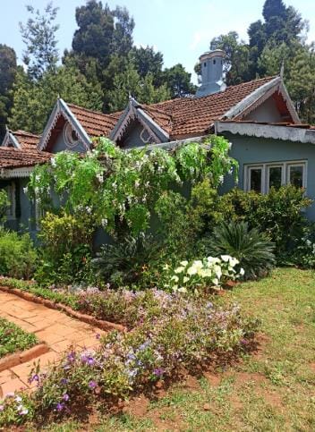 A flower bed beside a cottage